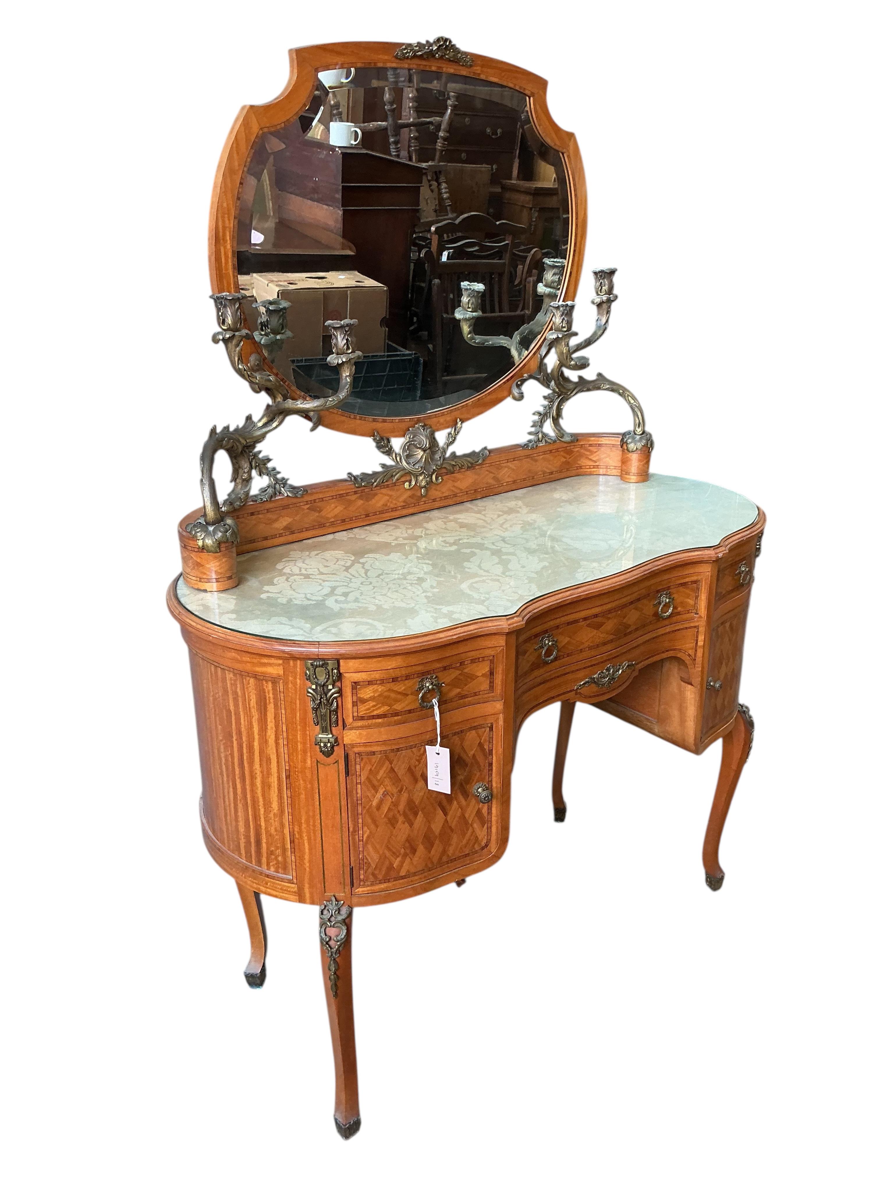 An early 20th century French transitional style gilt metal mounted tulip banded and parquetry inlaid kneehole dressing table, width 115cm, depth 50cm, height 160cm
